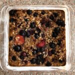Baking dish with baked berry and oatmeal.