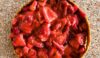 fresh strawberry pie in graham cracker crust sitting on a granite counter.